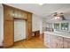 Kitchen area features wood cabinets, a desk, and opens to a living area at 1205 Southwood Dr, Newton, NC 28658