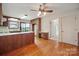Kitchen features wooden cabinets, tile countertops, wood floors, and natural light from the window at 1205 Southwood Dr, Newton, NC 28658