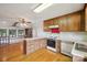 Kitchen features wood cabinets, a range oven, laminate countertops, and opens to a living area at 1205 Southwood Dr, Newton, NC 28658
