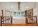 This bright open living room has a beam ceiling, fireplace, picture windows, and stairs leading up to it at 1205 Southwood Dr, Newton, NC 28658
