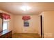 Simple bedroom with carpeting, natural light, and wood trim at 1491 Cedar Grove Rd, Clover, SC 29710