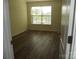 Empty bedroom with hardwood floors and bright, natural light from a window at 1502 Mulberry Ridge Dr # 1, Newton, NC 28658