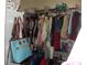 Walk-in closet with a variety of clothing hanging on rods and items on shelving at 1502 Mulberry Ridge Dr # 1, Newton, NC 28658