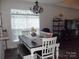 Dining room featuring chandelier, table with chairs, and natural light from large window at 1502 Mulberry Ridge Dr # 1, Newton, NC 28658