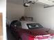 Attached garage with a red convertible, storage shelving, and a functional garage door opener at 1502 Mulberry Ridge Dr # 1, Newton, NC 28658
