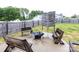 Cozy backyard patio with a modern fire pit and stylish wooden benches for outdoor relaxation at 1523 Loropetalum Rd, Charlotte, NC 28215