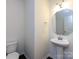 Elegant powder room featuring a pedestal sink, modern fixtures, and neutral decor at 1523 Loropetalum Rd, Charlotte, NC 28215