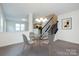 The dining area is open to the staircase and features a modern chandelier and gray chairs at 1523 Loropetalum Rd, Charlotte, NC 28215