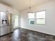 Bright and airy dining area with modern fixtures and stainless steel refrigerator at 1523 Loropetalum Rd, Charlotte, NC 28215