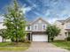 Two-story home with grey siding and stone accents over the garage at 1523 Loropetalum Rd, Charlotte, NC 28215