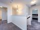 Upstairs hallway with neutral paint and carpet leading to bedrooms and bathrooms at 1523 Loropetalum Rd, Charlotte, NC 28215