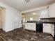 Kitchen features black appliances, white cabinets, and an open layout to the living area at 1523 Loropetalum Rd, Charlotte, NC 28215