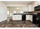 Well-lit kitchen with black appliances, granite countertops, and ample cabinetry at 1523 Loropetalum Rd, Charlotte, NC 28215