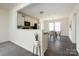 Open-concept living area featuring a modern kitchen and bright dining space at 1523 Loropetalum Rd, Charlotte, NC 28215