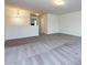 Bright and open living area featuring neutral walls and grey carpeting with modern light fixture at 1523 Loropetalum Rd, Charlotte, NC 28215