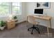 Bright home office featuring a modern desk, ergonomic chair, and natural light from large windows at 1523 Loropetalum Rd, Charlotte, NC 28215