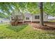 Charming backyard with a wooden deck, screened porch, and mature trees, offering a private and serene outdoor space at 1542 Crowders Woods Dr, Gastonia, NC 28052