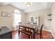Charming dining room featuring a wooden table, bench seating, and a bright, sunlit window at 1542 Crowders Woods Dr, Gastonia, NC 28052