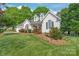 Charming two-story home with manicured lawn and garden beds at 1542 Crowders Woods Dr, Gastonia, NC 28052
