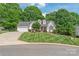 Well-maintained front lawn and manicured landscaping, complete with a driveway at 1542 Crowders Woods Dr, Gastonia, NC 28052