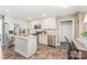 Well-lit kitchen with white cabinets, stainless steel appliances, central island, and dark tile flooring, perfect for cooking at 1542 Crowders Woods Dr, Gastonia, NC 28052