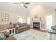 Bright living room with fireplace, ceiling fan, hardwood floors, and comfortable seating at 1542 Crowders Woods Dr, Gastonia, NC 28052