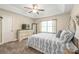 Comfortable bedroom with tray ceiling, dresser with TV, and large window for natural light at 1542 Crowders Woods Dr, Gastonia, NC 28052