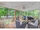 Inviting screened porch with ceiling fan, outdoor seating, and a view of the backyard at 1542 Crowders Woods Dr, Gastonia, NC 28052