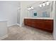 Bathroom with double vanity, cherry cabinets, and glass enclosed shower at 15923 Prescott Hill Ave, Charlotte, NC 28277