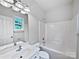 Bright bathroom with white vanity, white tile, and shower and bath combo at 15923 Prescott Hill Ave, Charlotte, NC 28277
