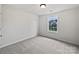 Bright bedroom with plush carpet, a modern ceiling light, and a window with natural light at 15923 Prescott Hill Ave, Charlotte, NC 28277