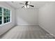 Bright bedroom with carpet flooring, a ceiling fan and large window with natural light at 15923 Prescott Hill Ave, Charlotte, NC 28277