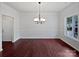 View of dining room with hardwood floors, wainscoting, chandelier, and large window at 15923 Prescott Hill Ave, Charlotte, NC 28277