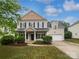 Charming two-story home with well-manicured lawn, black shutters, and inviting front porch at 15923 Prescott Hill Ave, Charlotte, NC 28277