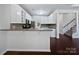Modern kitchen with white cabinets, grey countertops, breakfast bar, and stainless steel appliances at 15923 Prescott Hill Ave, Charlotte, NC 28277