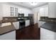 Well-lit kitchen with stainless steel appliances, dark countertops, and white cabinetry at 15923 Prescott Hill Ave, Charlotte, NC 28277