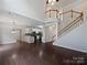 Open floor plan features a modern kitchen, hardwood floors, and tall ceilings with staircase at 15923 Prescott Hill Ave, Charlotte, NC 28277