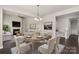 Well-appointed dining room with fireplace seamlessly connects the living spaces, perfect for gatherings at 16134 Kelby Cv, Charlotte, NC 28278