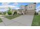 Beautiful two-story home with a welcoming front porch, two-car garage, and lush green lawn at 16134 Kelby Cv, Charlotte, NC 28278