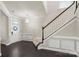 Elegant foyer featuring a staircase, dark hardwood floors, and decorative molding at 16134 Kelby Cv, Charlotte, NC 28278