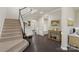 Grand foyer with a staircase, dark hardwood floors, and elegant decor at 16134 Kelby Cv, Charlotte, NC 28278