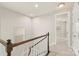 Bright hallway with neutral walls, wood railing, and view to bedroom at 16134 Kelby Cv, Charlotte, NC 28278