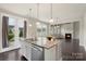 Bright kitchen features granite counters, an island, stainless appliances, and access to the outdoors at 16134 Kelby Cv, Charlotte, NC 28278