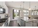 Open kitchen design with stainless appliances, granite countertops, and access to outdoor patio at 16134 Kelby Cv, Charlotte, NC 28278