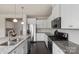 Modern kitchen featuring granite countertops, stainless steel appliances, and ample cabinet space at 16134 Kelby Cv, Charlotte, NC 28278
