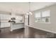 Bright, open kitchen with white cabinets, granite countertops, and stainless steel appliances at 16134 Kelby Cv, Charlotte, NC 28278