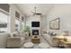 Bright living room featuring a cozy fireplace, plush seating, and ample natural light at 16134 Kelby Cv, Charlotte, NC 28278