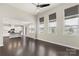 Open-concept living area with abundant natural light, hardwood floors, and seamless kitchen access at 16134 Kelby Cv, Charlotte, NC 28278