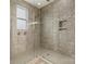 Shower room featuring gray tiles, glass door, and built-in niche at 16134 Kelby Cv, Charlotte, NC 28278
