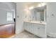 Well lit bathroom featuring a double sink vanity with white cabinets and neutral toned flooring at 1835 Montague Rd, Clover, SC 29710